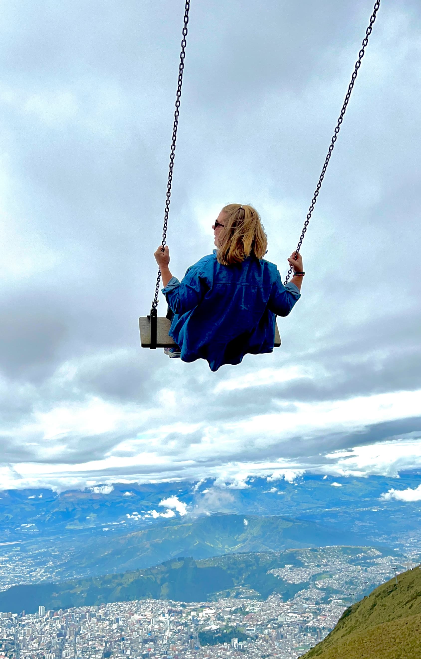 Person sitting on a swing, enjoying the view
